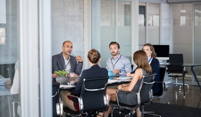 Business people sitting in boardroom and working together at new strategy plan. Group of leader and businesspeople in a meeting at office. Senior executive with his team working in a conference room.